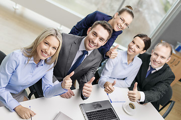 Image showing business team showing thumbs up in office