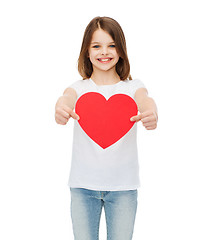 Image showing smiling little girl giving red heart