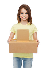 Image showing smiling little girl with many cardboard boxes