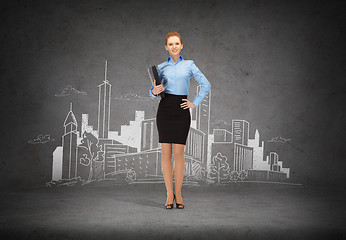 Image showing smiling businesswoman with folder