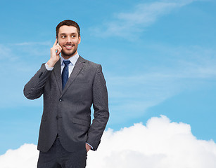 Image showing young smiling businessman with smartphone