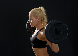 Image showing sporty woman exercising with barbell