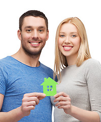 Image showing smiling couple holding green paper house