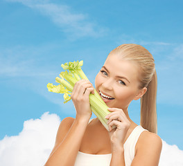 Image showing woman biting piece of celery or green salad