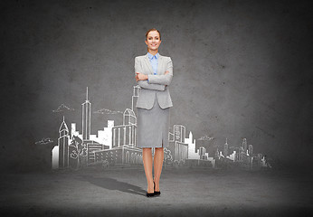 Image showing young smiling businesswoman with crossed arms