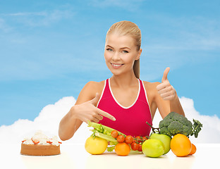 Image showing woman pointing at healthy food