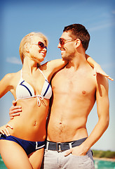 Image showing happy couple in sunglasses on the beach