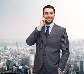 Image showing young smiling businessman with smartphone