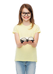 Image showing smiling cute little girl in black eyeglasses