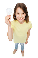 Image showing smiling little girl holding light bulb