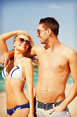 Image showing happy couple in sunglasses on the beach