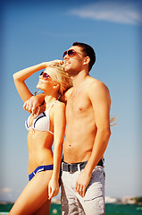 Image showing happy couple in sunglasses on the beach