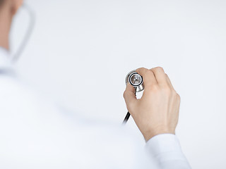 Image showing doctor hand with stethoscope listening somebody