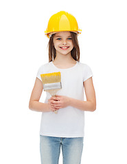 Image showing smiling little girl in helmet with paint brush