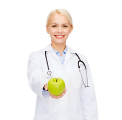 Image showing smiling female doctor with green apple