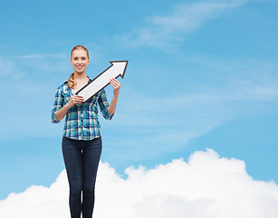 Image showing smiling young woman with arrow poiting up