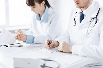 Image showing doctor and nurse writing prescription paper