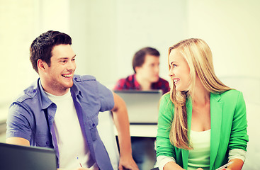 Image showing smiling students looking at each other at school