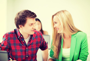 Image showing smiling students looking at each other at school