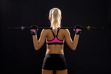 Image showing sporty woman exercising with barbell