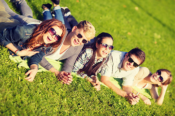 Image showing group of students or teenagers lying in park