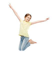 Image showing smiling little girl jumping