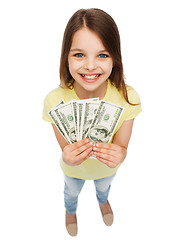 Image showing smiling little girl with dollar cash money