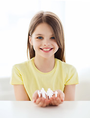 Image showing smiling little girl showing paper man family