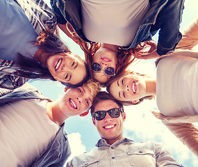 Image showing group of teenagers looking down