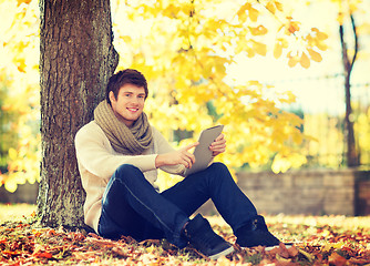 Image showing man with tablet pc in autumn park