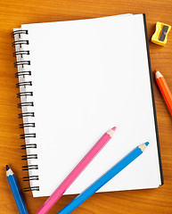 Image showing Notepad with color pencils