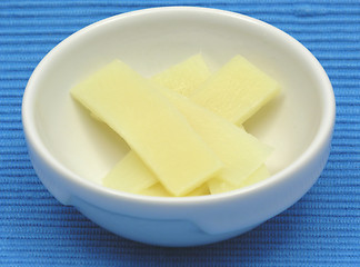 Image showing bamboo in a bowl of chinaware on blue background