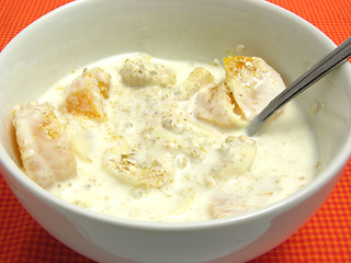 Image showing Yoghurt with banana cutted into pieces, tangerine and oat flakes