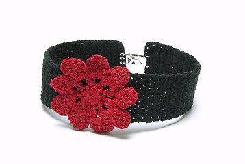 Image showing Black crocheted collar with one red crocheted flower