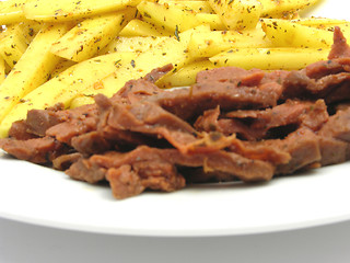 Image showing Soy Geschnetzeltes and french fries on white plate
