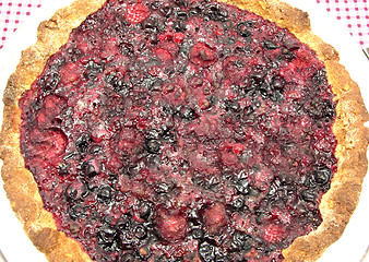 Image showing Delicious berry cake on a tray and checkered table cloth