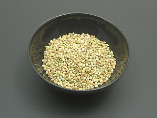 Image showing Bowl of chinaware with buckwheat on a dull matting