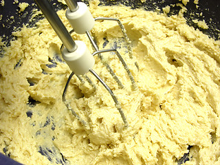 Image showing Margarine and cane sugar mixed with stirring staffs in a blue bo