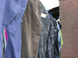 Image showing Clothesline outside the house with some laundered clothes