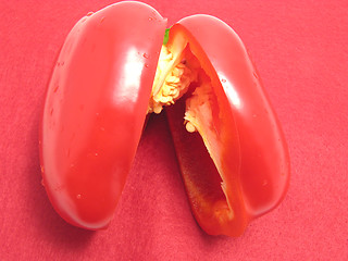 Image showing Red pepper cutted into halves on a red placemat