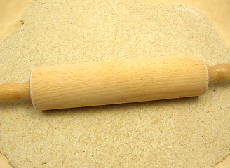 Image showing Rolled out  wholemeal dough with a rolling pin