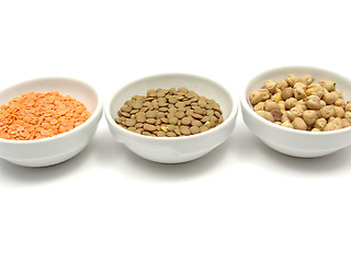 Image showing Three bowls of chinaware with garbanzos lentils and red lentils