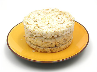 Image showing Slices of puffed rice arranged on a bowl of ceramik on white