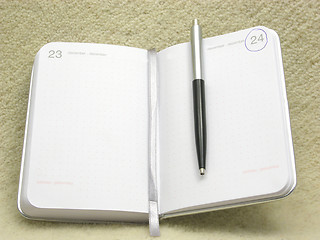 Image showing To flip an appointment calendar open with ball pen