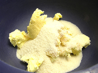 Image showing Pieces of margarine and cane sugar in a blue bowl