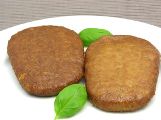 Image showing Two breaded bean curd cutlets on a white plate