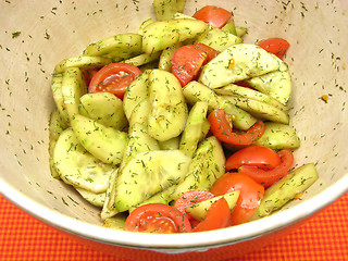 Image showing Cucumbers and tomatoes with salat dressing in a bowl of ceramics
