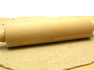 Image showing Rolled out  wholemeal dough with a rolling pin