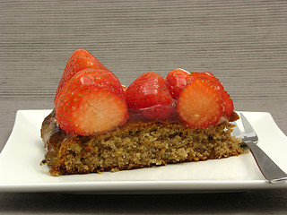 Image showing One slice of strawberry cake on white plate on gray background