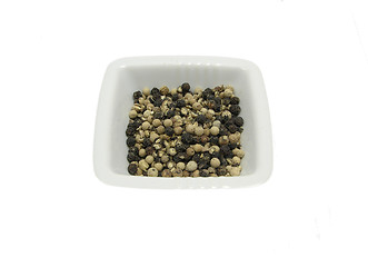 Image showing Isolated white bowl of chinaware with pepper corns